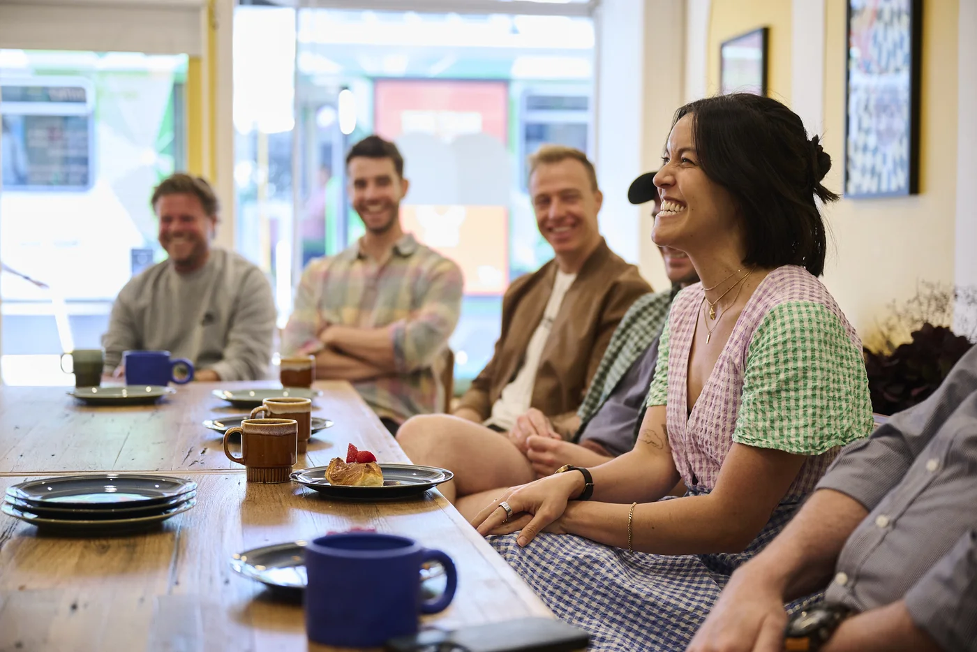 Sublime members smiling together around a breakfast table